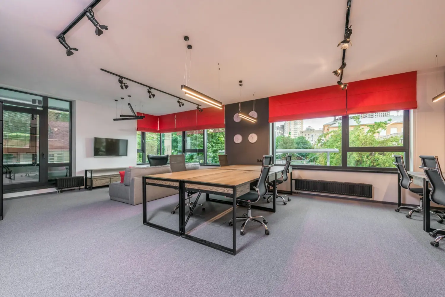 A modern office with wall-to-wall carpet and natural light — the space ready for use after cleaning.